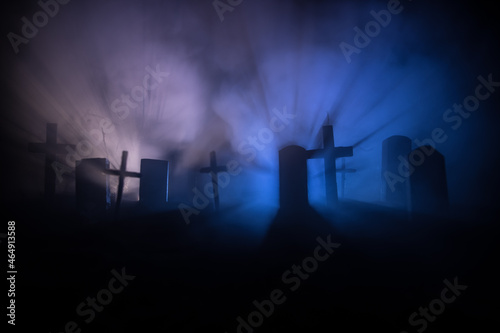 Scary view of zombies at cemetery dead tree  moon  church and spooky cloudy sky with fog  Horror Halloween concept with glowing pumpkin. Selective focus