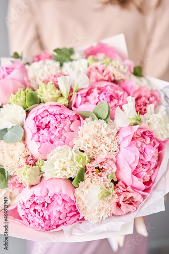 Beautiful bouquet of mixed flowers in woman hand. Floral shop concept . Handsome fresh bouquet. Flowers delivery.