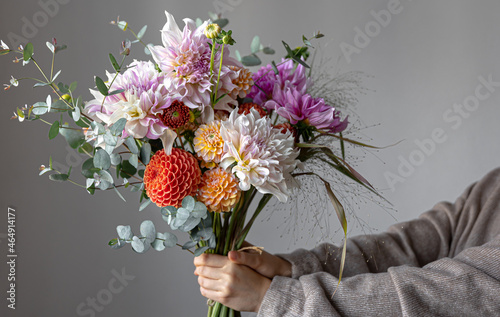 Close-up of a bright festive bouquet with chrysanthemums in female hands. photo