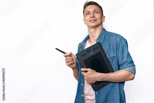 A male designer in casual style holding graphic tablet