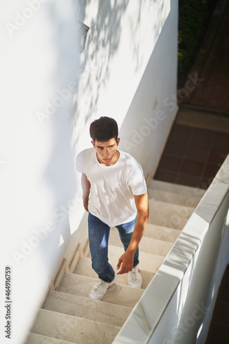 Young man walking on stairway of building