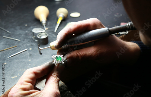 Jewelry workshop. Jeweler holding a diamond emerald ring