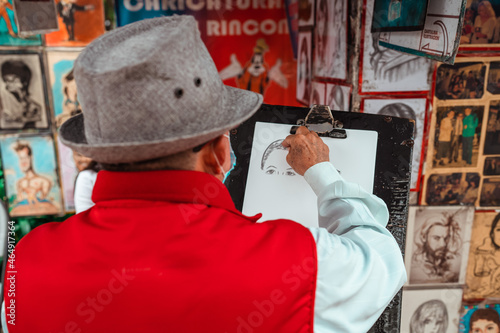 cartoonist painting a person on the street photo