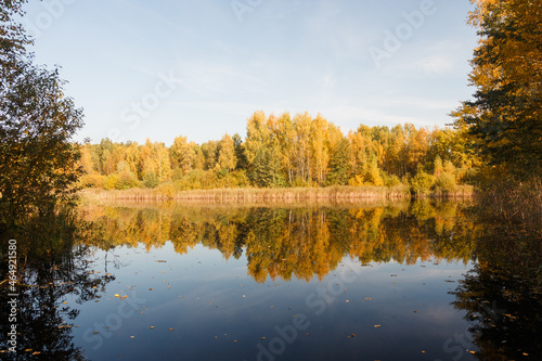 Little lake in Moscow region, Russia. Sunny day in October. Reflections in water
