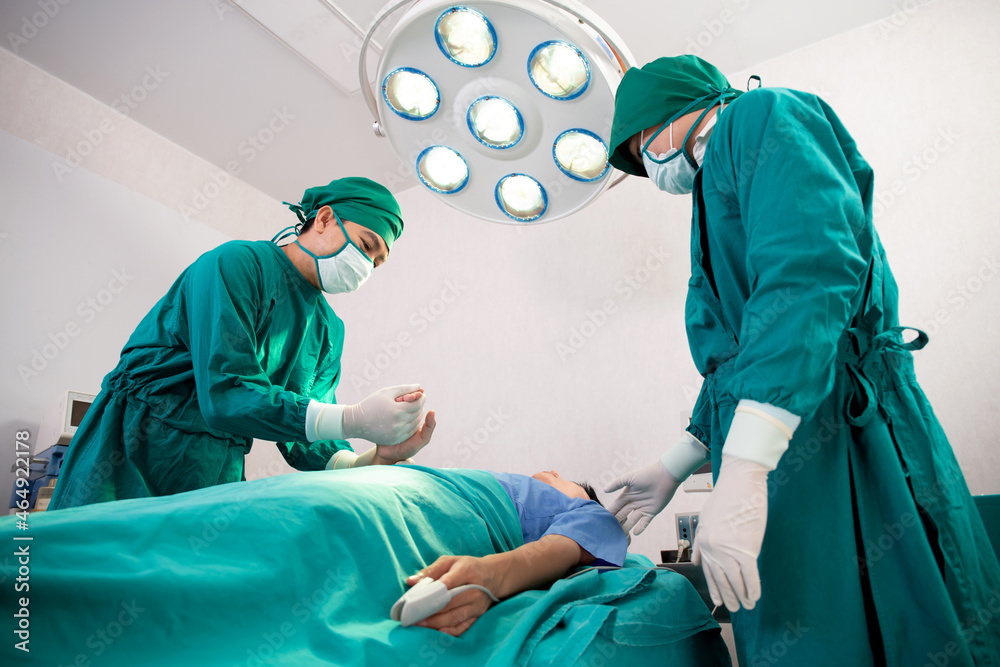 Doctor shake hands with patient for encourage and trust at hospital, surgeon encouragement patient before surgery for healing with emergency in the operation room, medical and health concepts. Doctor shake hands with patient for encourage and trust at hospital, surgeon encouragement patient before surgery for healing with emergency in the operation room, medical and health concepts.