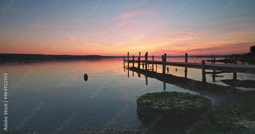 Sunset over the sea lake and old wooden pier
Sunset over the sea lake and old wooden pier