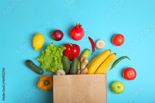 Products in a paper bag on a colored background with place for text top view.