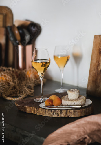 Orange or Amber wine in wineglass and appetizers snacks