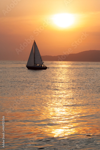 Sailboat sailing in a beautiful summer sea during sunset