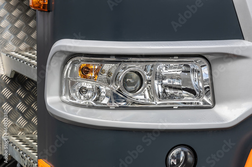 New truck headlight. Detail of a lorry close up. Truck electrical equipment. Road safety