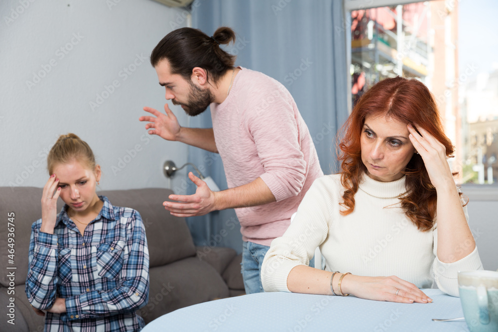 Fototapeta premium Portrait of sad mature woman sitting after conflict with adult children in home interior