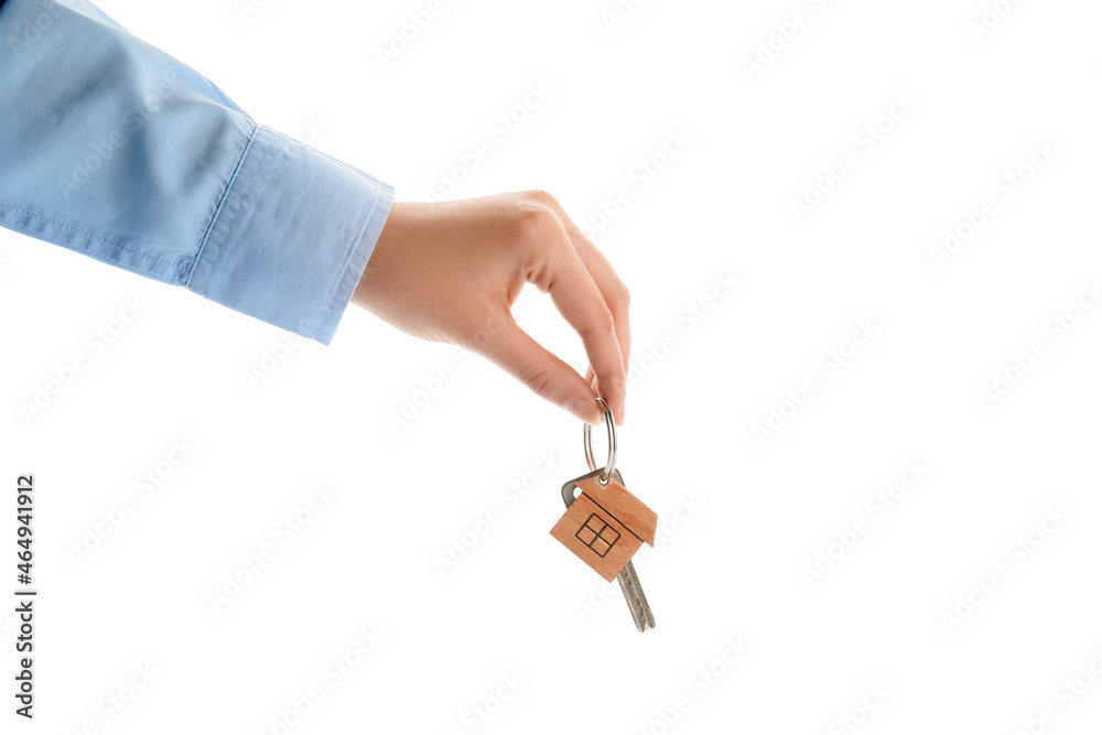 Obraz premium Real estate agent holding key with house shaped keychain on white background