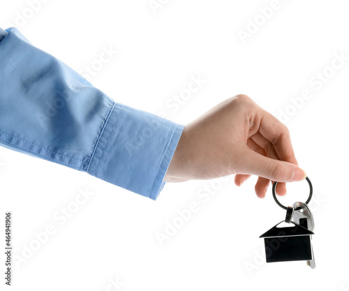 Real estate agent holding key with house shaped keychain on white background