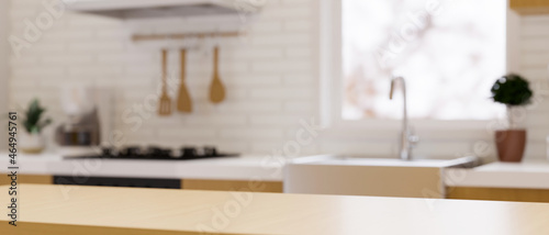 Wooden dining table top for montage over blurred modern contemporary kitchen space photo