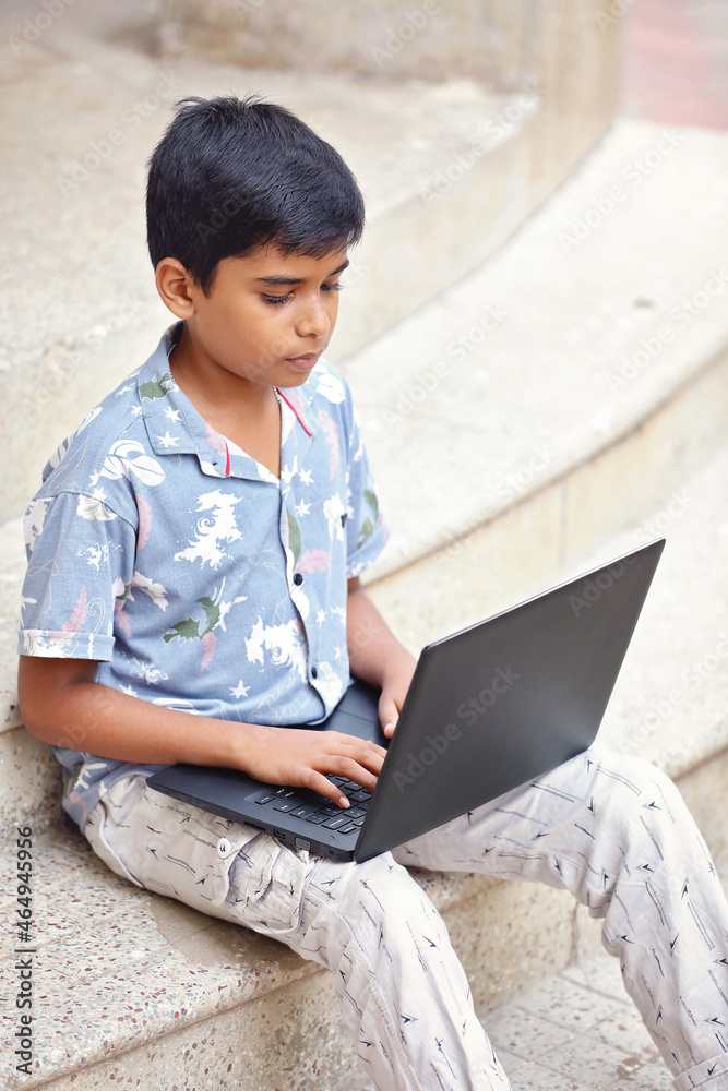 Portrait of Indian little boy using Laptop for online class
Portrait of Indian little boy using Laptop for online class