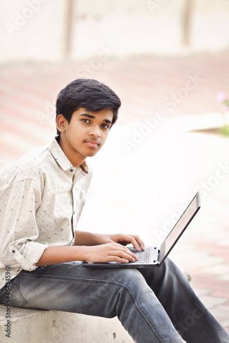 Indian boy using a laptop while attending the online classes at home   © V.R.Murralinath
