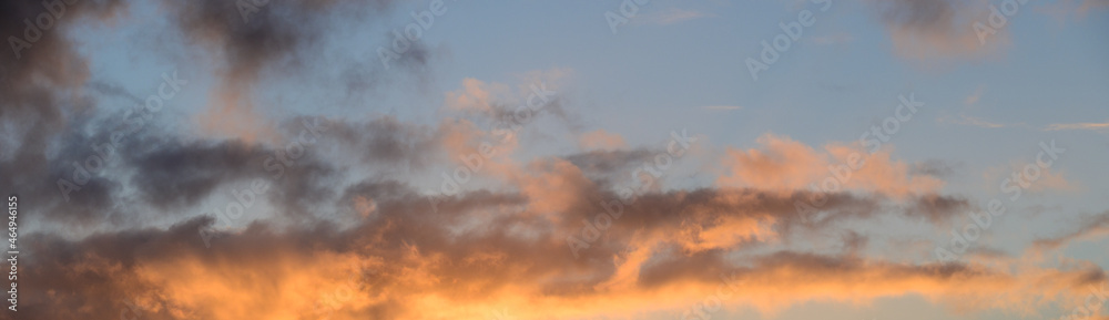 Dramatic sunset with light blue sky and colorful bright clouds, as a nature background Dramatic sunset with light blue sky and colorful bright clouds, as a nature background