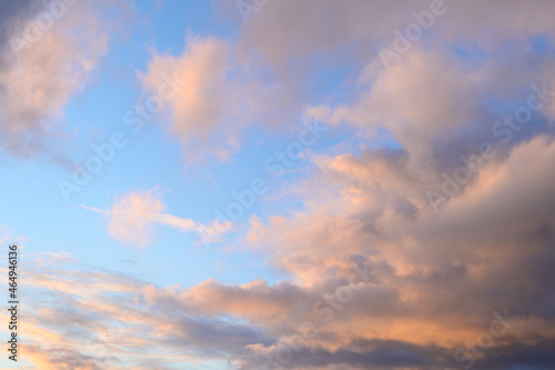 Fluffy ethereal pastel clouds lighted by the fading sun  as a nature background 