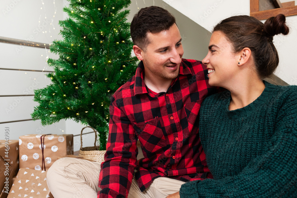Smiling young caucasian couple at home celebrate Christmas together. Smiling young caucasian couple at home celebrate Christmas together.