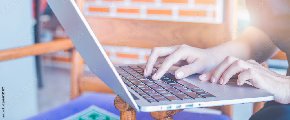 Business woman hand using laptop computer in the office.for web banner.