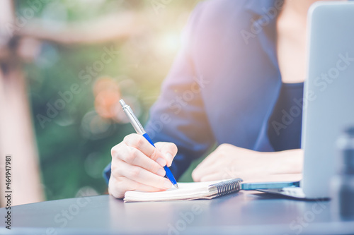 Obraz na płótnie Business woman hand writing on a notepad with a pen in the office. w salonie