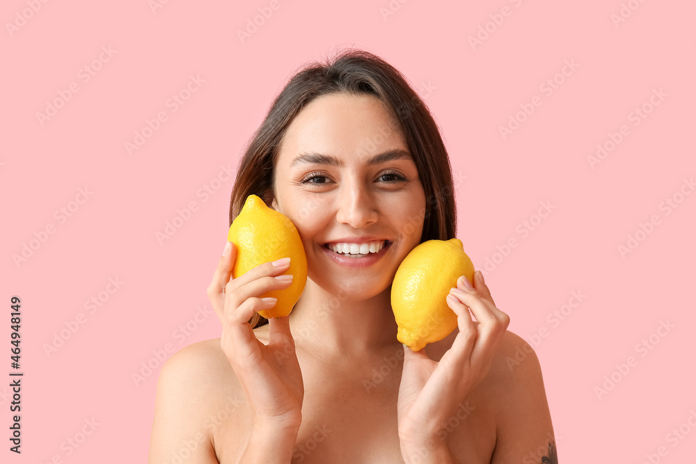 Naked young woman with fresh lemons on color background. Vegan Day Naked young woman with fresh lemons on color background. Vegan Day