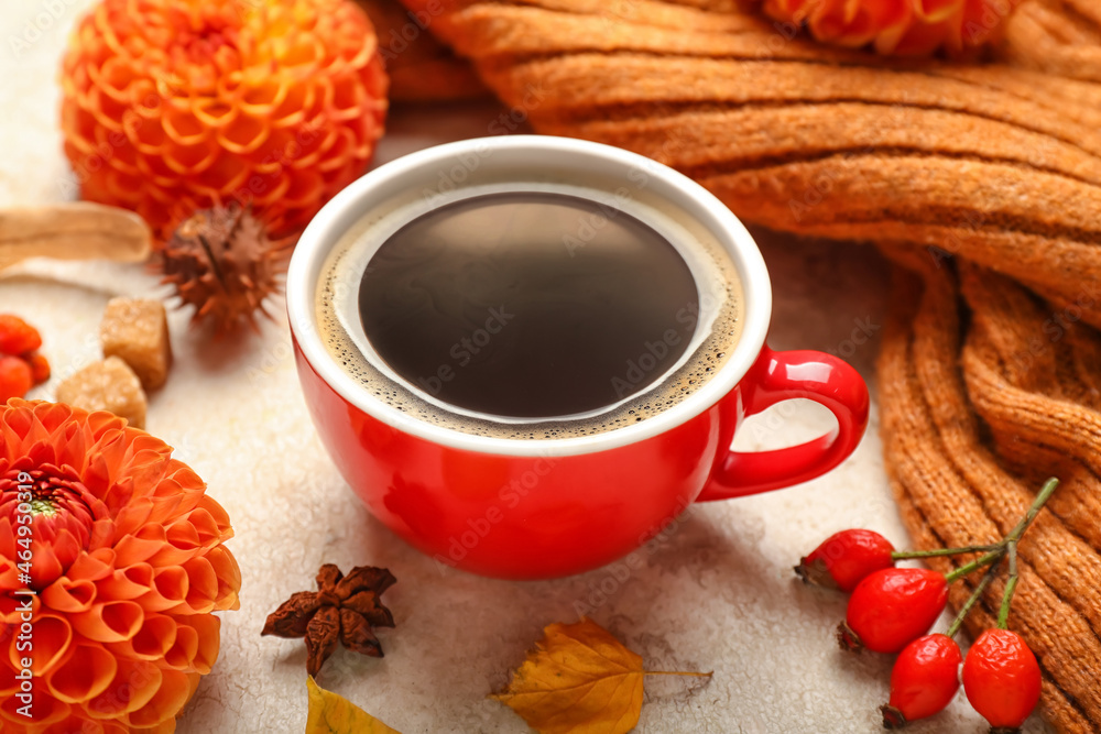 Beautiful autumn composition with cup of coffee, chrysanthemum flower and sweater on light background
