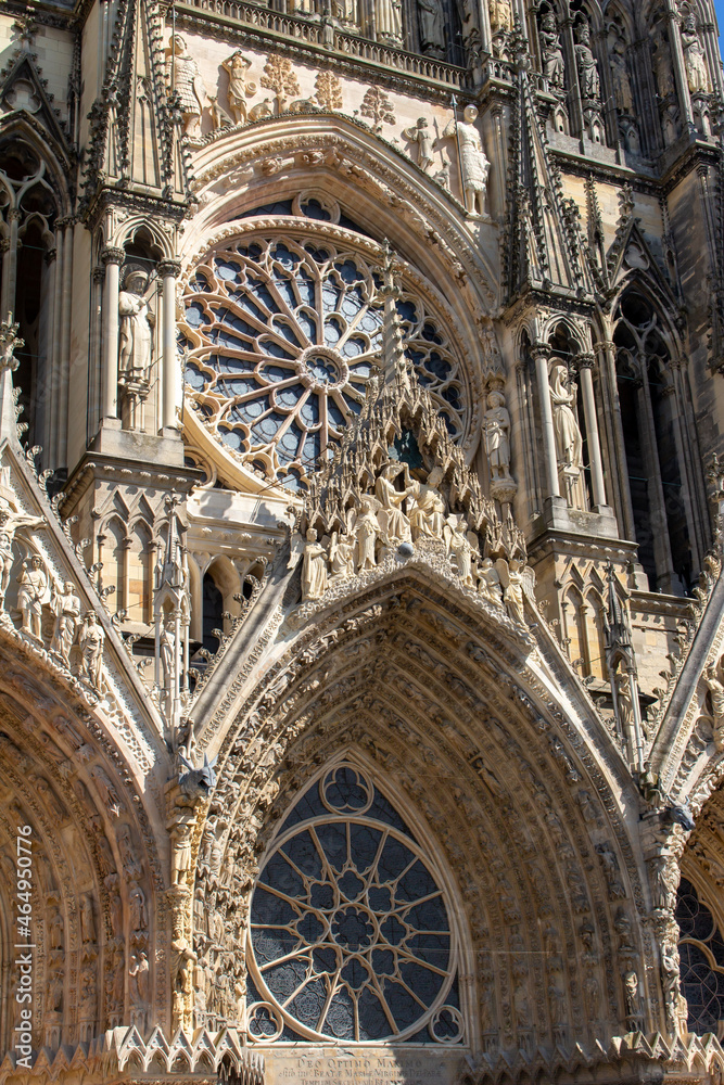 Close up view of the ornate medieval Our Lady of Reims Cathedral (Notre-Dame de Reims) in France, with high Gothic architecture, showing its central rose window