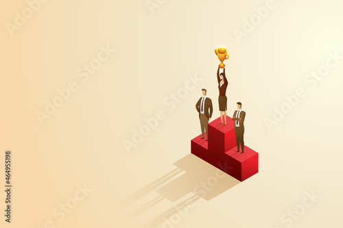 Businesswoman holds a trophy on a podium above a businessman.