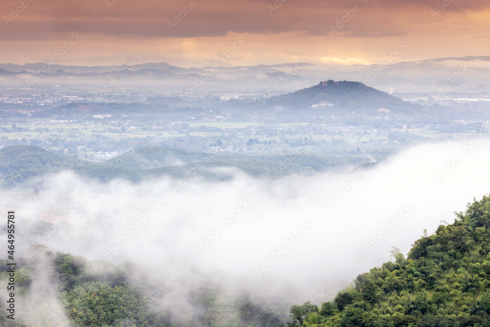 Obraz premium Aerial view of Sun rise with fog Over City and mountain range at Chiangrai Thailand, date photo taken 20 October 2021