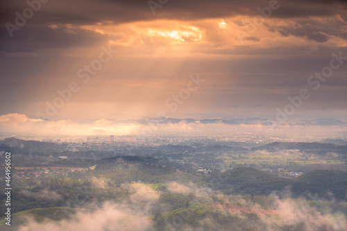 Aerial view of Sun rise with fog Over City and mountain range at Chiangrai Thailand, date photo taken 20 October 2021