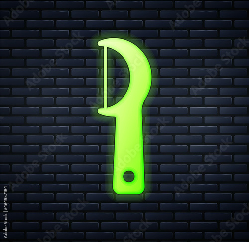 Glowing neon Dental floss icon isolated on brick wall background. Vector