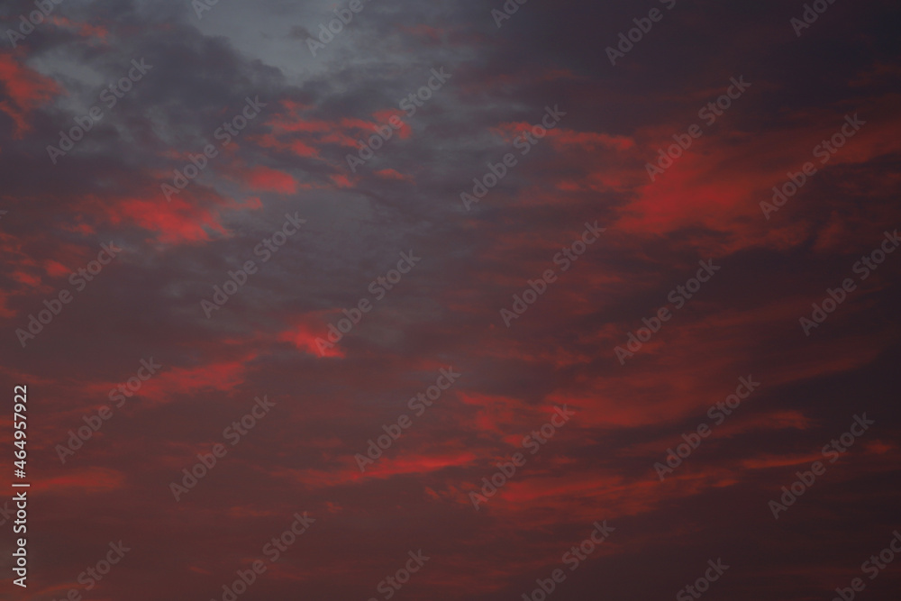 dramatic clouds in crimson color during sunrise