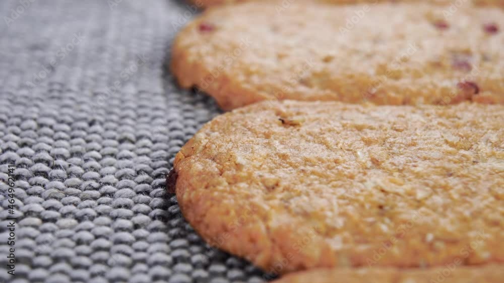 Freshly baked oat biscuits stacked in rows. Macro. Dolly shot. Oatmeal cookies. On a rustic jute mat Freshly baked oat biscuits stacked in rows. Macro. Dolly shot. Oatmeal cookies. On a rustic jute mat