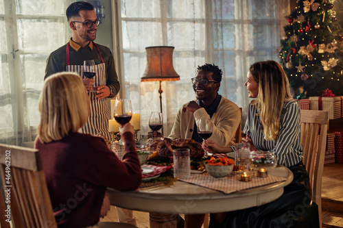 Diverse friends enjoying Christmas together at home