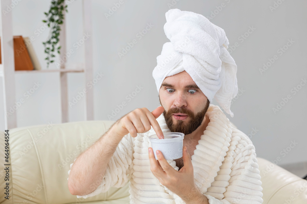 Portrait of man applying effective cream on his facial skin. Spa at home, body and skin care for male concept. Portrait of man applying effective cream on his facial skin. Spa at home, body and skin care for male concept.