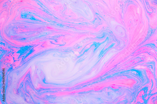 Abstract colored marble background, stains of pink and blue paint on the surface of the water. Liquid colorful backdrop.