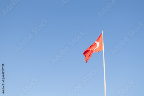 Turkish national flag on a blue sky background. Flag of the country Turkey