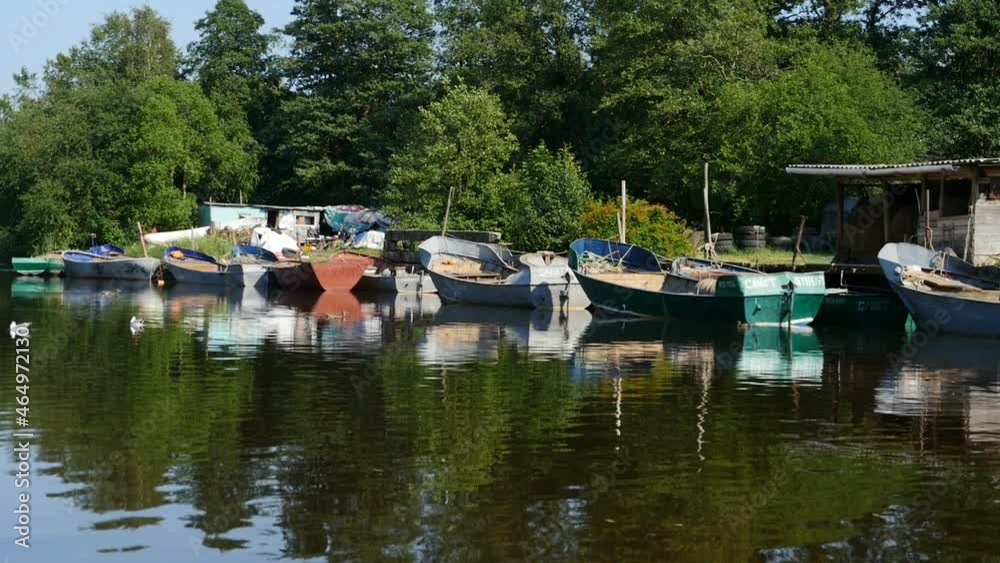 pier with fishing boats on the river view from the boat summer river landscape pier with fishing boats on the river view from the boat summer river landscape