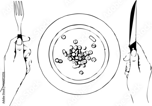 A handful of pills, capsules and  tablets on a plate next to cutlery. Taking medication. Pills instead of food. The concept of vitamins instead of food
