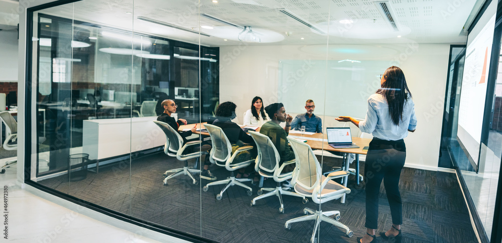 Fototapeta premium Creative businesswoman giving a presentation in a boardroom