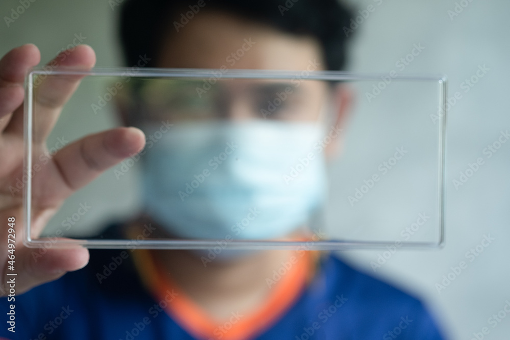 Asian smart man wear medical mask and show empty tag for your design Asian smart man wear medical mask and show empty tag for your design