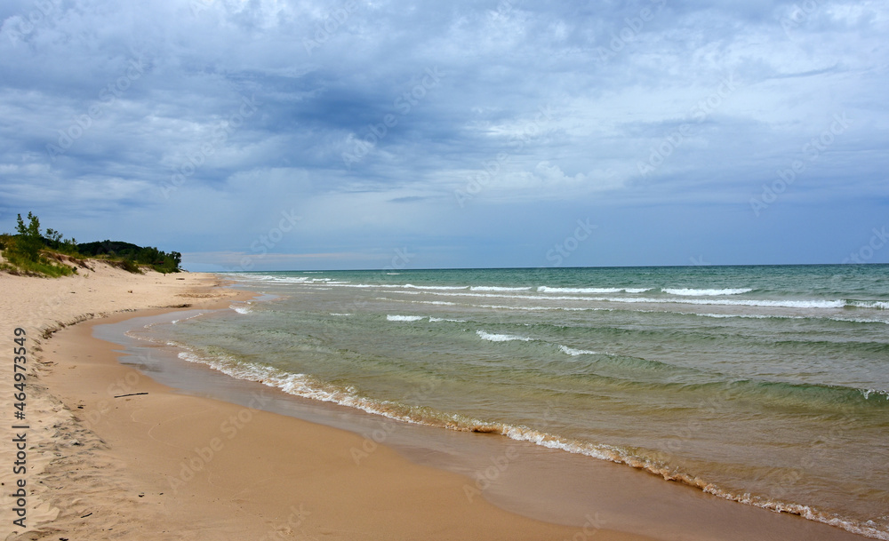 the picturesque beach next to  the little sable point lighthouse in silver lake state park on lake michigan, in mears, michigan