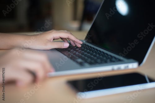 Close-up of fingertips touching laptop keyboard