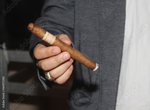 hand holding a cigar
