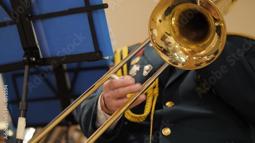 Brass military band.Hands close-up playing instruments.The orchestra is playing indoors.