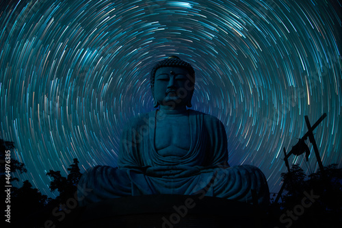 The stars night of startails over Big buddha in Daibutsu or Great Buddha popular Buddhist shrine in Thailand photo