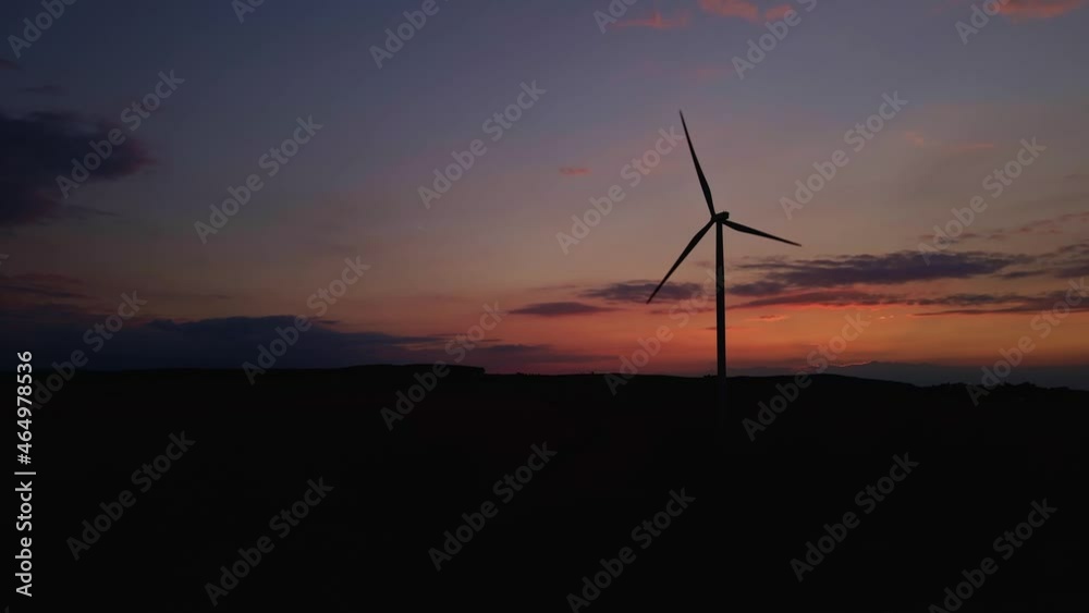 Windmill silhouette at sunset sky. Wind turbine generator. Wind energy concept. Suistanable and renewable energy for climate protection
