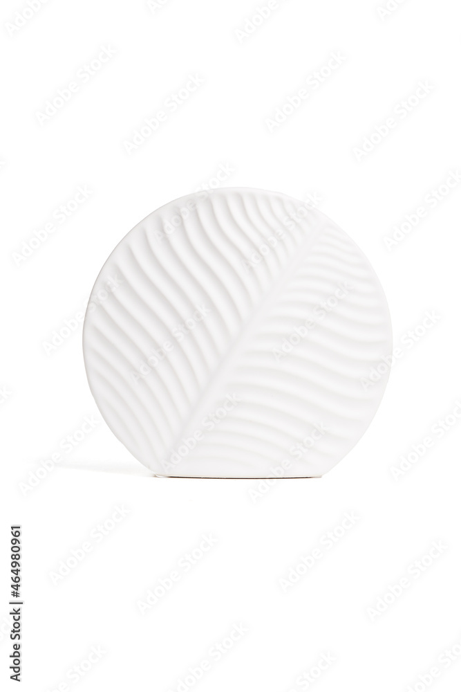 Detailed shot of the white vase. The vase has a form of circle. Surface of vase is relief. White decor item is isolated on the white background. Detailed shot of the white vase. The vase has a form of circle. Surface of vase is relief. White decor item is isolated on the white background.