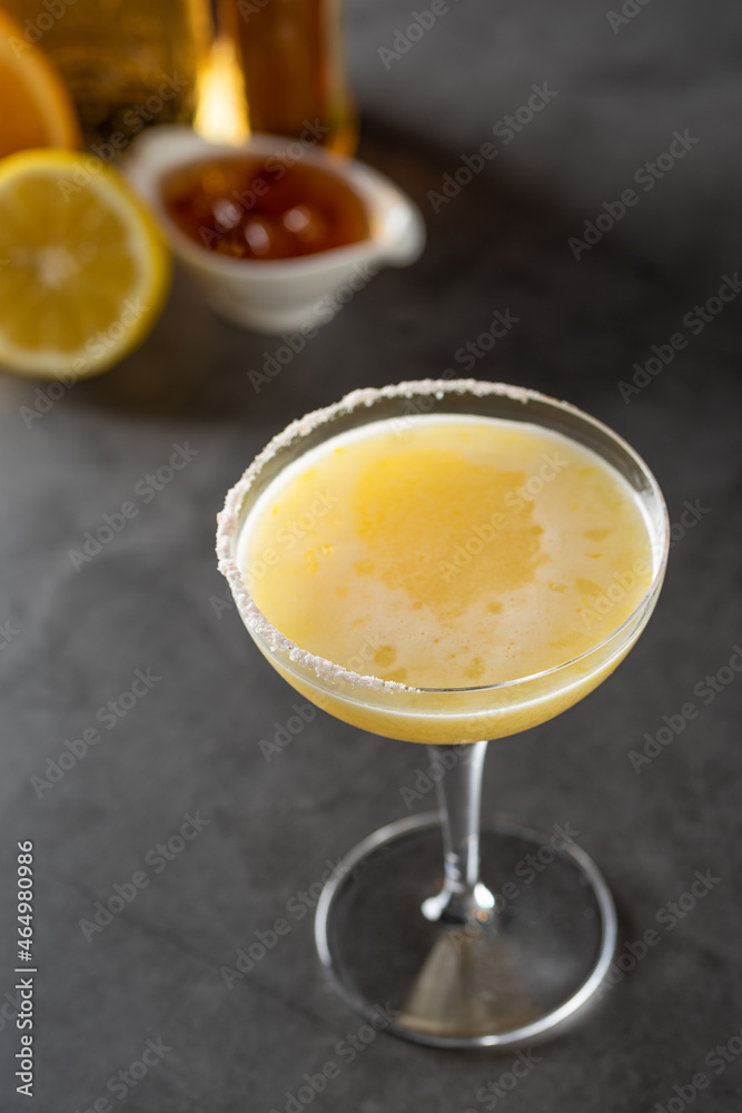 Luxury cocktail with lemon and tequila on a dark stone background Luxury cocktail with lemon and tequila on a dark stone background